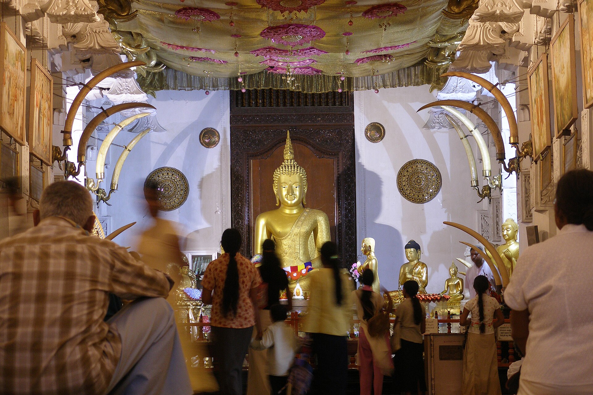 Worshippers before the gilded inner shrine of Sri Dalada Maligawa, the Temple of the Sacred Tooth Relic in Kandy