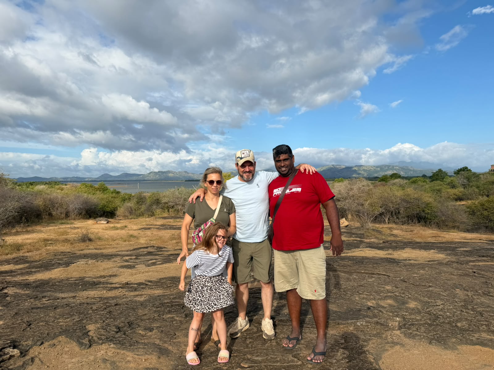 A family with their Mathew Tours guide at a lake viewpoint in the dry zone